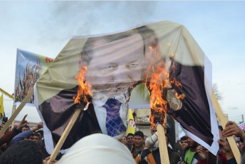 theygiveusnochoice: Kurds at a protest for Afrin in Kobanê burn the image of Erdogan.