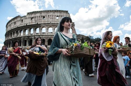 Photo: Actors dressed as ancient Roman maids march in front of the Coliseum in a commemorative parad