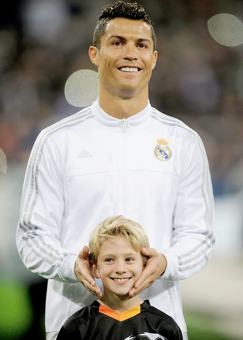 madridistaforever:  Cristiano Ronaldo jokes with a player escort during the UEFA