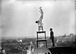 John &lsquo;Jammie&rsquo; Reynolds performing an acrobatic and balancing act on top of the Lansburgh Building in Washington, D.C. circa 1917.