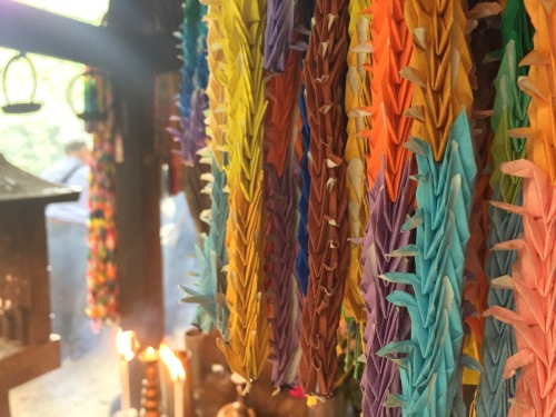 A shrine was decorated with bushels of paper cranes. Each bushel should hold exactly a thousand bird