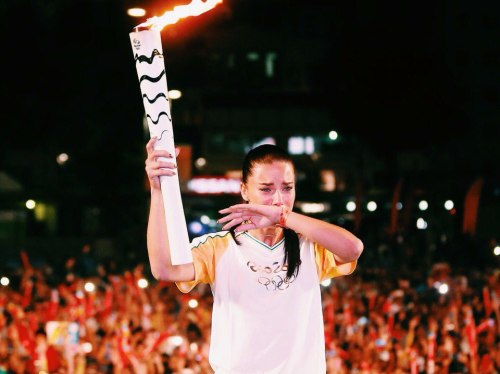 Adriana Lima carries the Olympic torch in Brazil