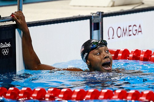 scatter-the-stars: Simone Manuel reacts after winning the 100m freestyle race. She became the first 