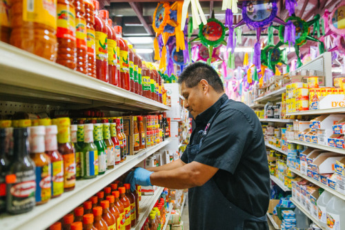 Senen Aguilar, owner of Pantera Market, stocks a shelf at his shop in Caldwell, Shot for the Idaho B