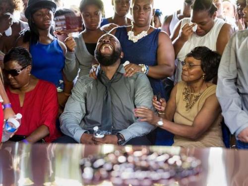 kumikonaimah:  planetfaraway:  kingjaffejoffer:  Michael Brown’s dad before the burial.  The emotion and all of the sweat…. shit is hard to look at, even if its only a picture  goodness.  This is not okay.Look to the left. She couldn’t even stand