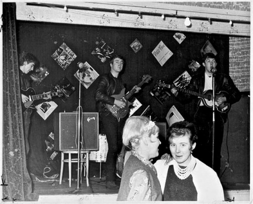 ‪The Beatles performing for a roaring crowd of 18 people at the Palais Ballroom in Aldershot. Decemb