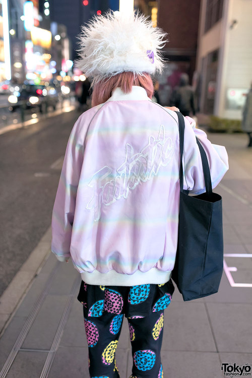 Mamina on the street in Harajuku after dark wearing a fuzzy hat with a graphic setup from Galaxxxy, 