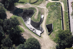 subtilitas:  Anne Holtrop -  Fort Vechten Waterline museum, Bunnik 2015. An ‘excavated’ underground museum on the site of a historic defensive fort that protected Utrecht, the museum features undulating walls of brown concrete and brass windows