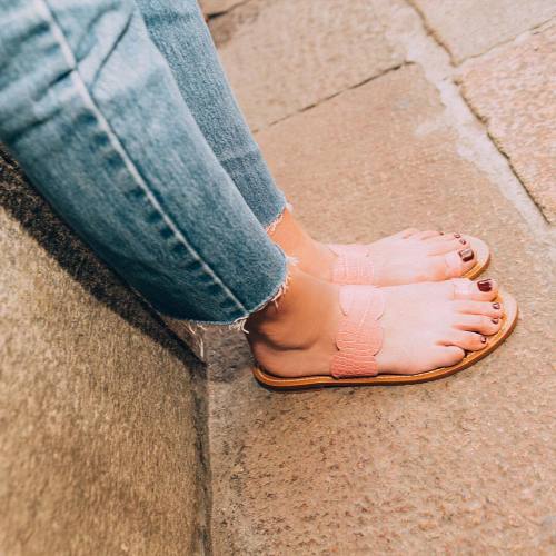 Leather toe ring sandals on pretty feet.