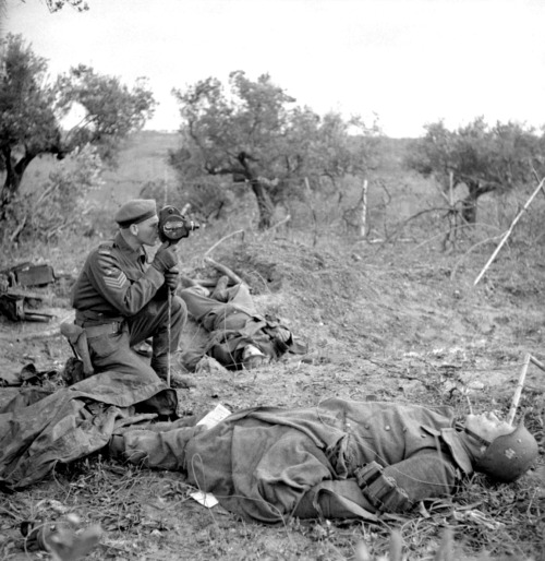 bag-of-dirt:Canadian Army Sgt. George A. Game of the Canadian Film and Photo Unit operates his camer