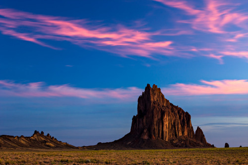 old-hopes-and-boots:Shiprock abruptly stands in the northwestern corner of New Mexico. In the Navajo language, it is called “Tsé Bitʼaʼí,” which means rock with wings or winged rock. by Beau Rogers