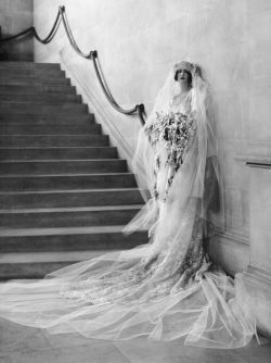 mote-historie:   Cornelia Vanderbilt, Wedding gown design by   Farquharson &amp; Wheelock,   Biltmore House (Biltmore Estate), April 29, 1924.   The silk slipper-satin, long-sleeve sheath with lace tunic bridal confection was created by society designers