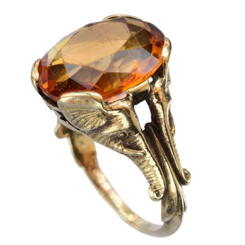 eriebasin:The coolest c1900 ring, with elephant heads supporting a bright orange citrine, and their 