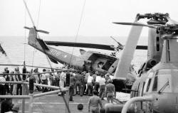 historicaltimes: Soldiers push a helicopter off an aircraft carrier to make room for incoming South Vietnamese refugees, 1975 via reddit 