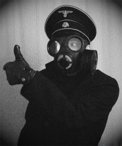 taintedgarden:  Model Nazi officer, wearing a gas mask for advertising before the second world war.