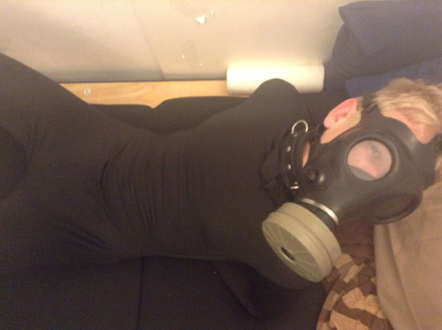 pupdonnie:  In a morphsuit with legs spread wide and hands securely shackled, pupdonnie’s eyes grow wide in horny anticipation from behind the restrictive gas mask. 