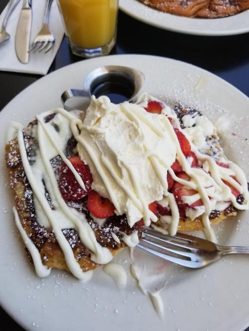 [I ate] Cream cheese croissant french toast with strawberries and whipped cream.