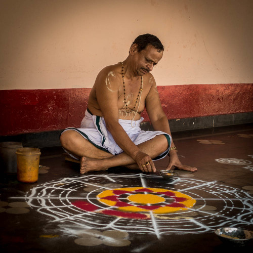 Brahmana doing a yantra with colored powders for a ritual, Udupi, Karnataka