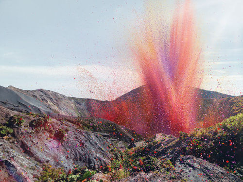 fun123joker:justgo-up:thousands of flower petals covering a town, blasted from a neighboring volcano