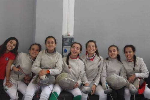 modernfencing: [ID: a row of young sabre fencers smiling at the camera.]Fencers at the 2016/17 Alger