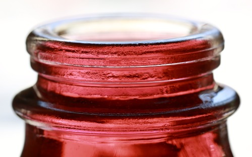 glass mouthglass milk jug filled with colored water