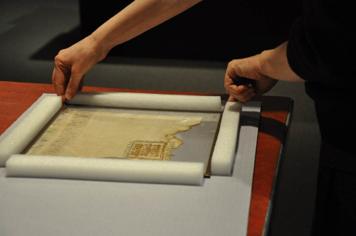 Chief Conservator Esther Méthé is working on packing our small collection of textile f
