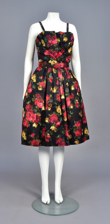 historicaldress: SUZY PERETTE WARP PRINTED COCKTAIL DRESS, 1950s Sleeveless black satin with colorfu