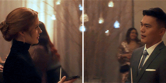 GIF FROM EPISODE 3X10 OF NANCY DREW. THE GIF IS SPLIT TO MAKE IT LOOK LIKE TWO DIFFERENT GIFS. NANCY AND AGENT PARK ARE STANDING FACING EACH OTHER AT THE CANDLE-LIGHTING CEREMONY AS THE CAMERA PANS AROUND THEM.