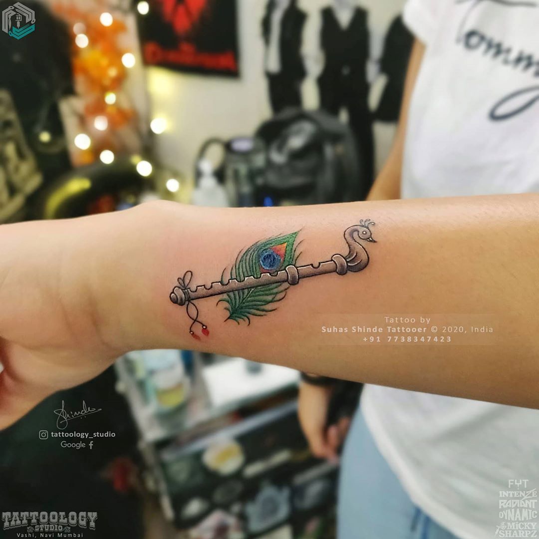 Flute with peacock feather Tattoo Design On Wrist Tattoo Done By Artist  Bipin At S.S Zone Tattoo Studio Shop No.7a 1st Floor Gaur City… | Instagram