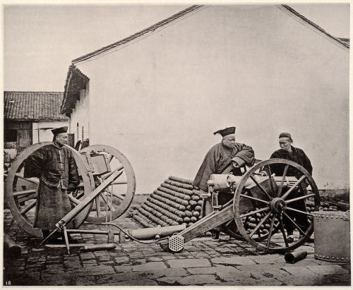 Chinese ordnance officials examine a French Montigny Mitrailleuse machine gun at the Nanjing Jinling
