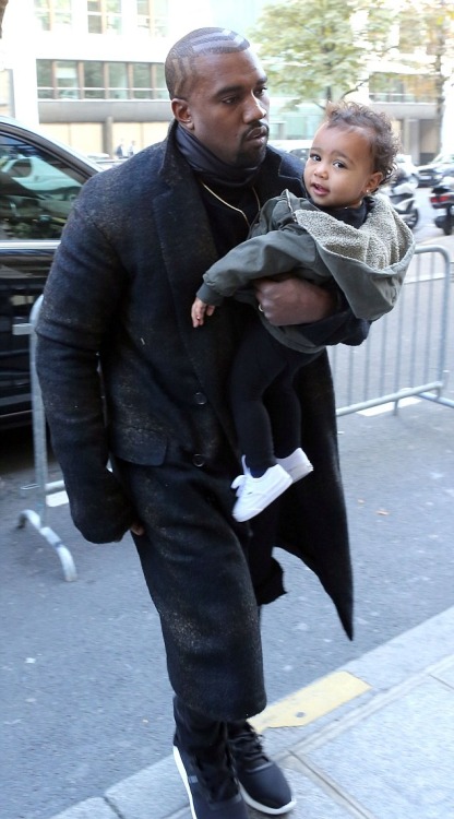 kimkanyekimye:Kanye carrying North as they arrive to their Paris hotel 9/24/14