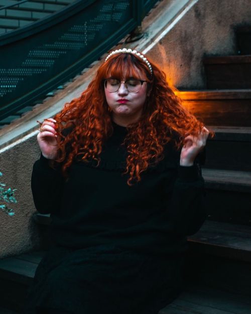 The many faces of a random ginger on some steps; featuring a dark and gloomy background and mood. ■━