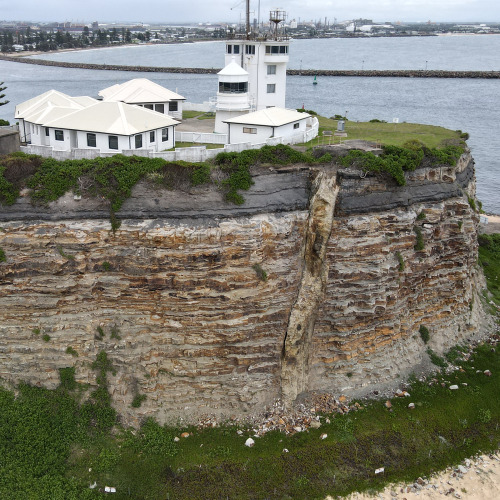 2020: Nobbys Head is an outcrop of Permian coal measures at the entrance of the Hunter River. Origin