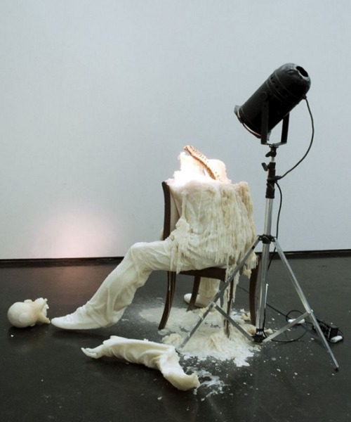 asylum-art:  Tatiana Blass’s Wax Figures Melt  Tatiana Blass built a human body that leans over the spine of a chair. She built this body out of wax and gave it a spotlight to shine; however, its glow not only illuminated, but also curdled the figure’s