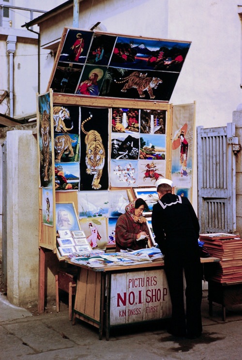 s-h-o-w-a:  Sailor shopping at “Robber’s Alley”, Yokosuka, Japan, Dec 12. 1953