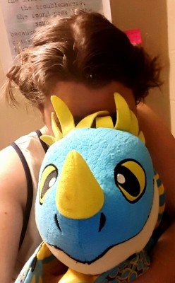 Buns in my hair, stuffie on my lap (Mr. Blue),