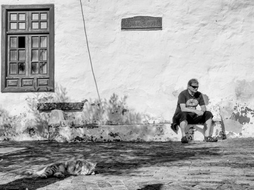 Sitting man and sleeping catStreets of LanzaroteDec.  2021