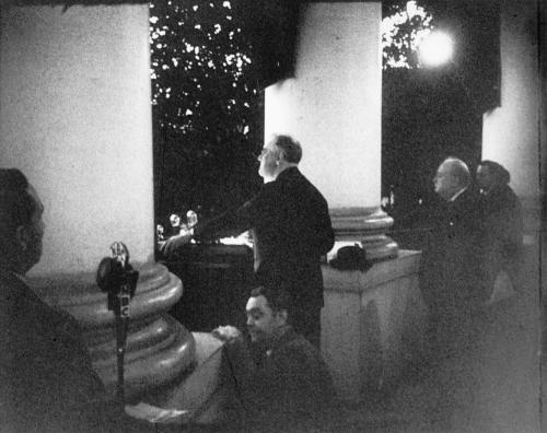 Prime Minister Winston Churchill looks on as President Franklin Roosevelt addresses the crowd at the Christmas tree lighting ceremony from the White House South Portico, December 24th, 1941. [3000 x 2375] Check this blog!