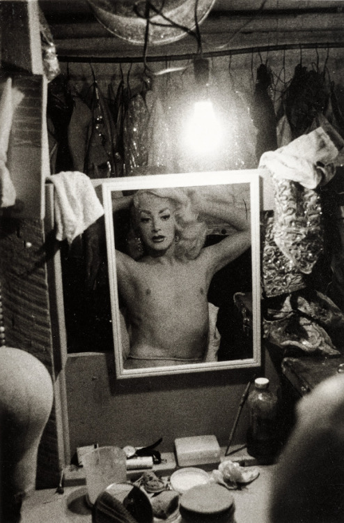 joeinct:Blonde female impersonator framed in a mirror beneath a light bulb, NYC, Photo by Diane Arbu