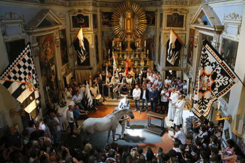 A horse blessing ceremony in the church of Saint Rocco before the famous Palio horse race in Siena, 