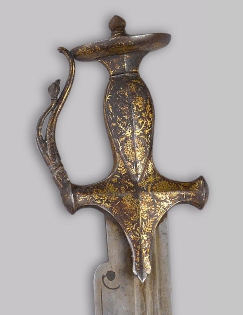 An Unusual Tulwar-Hilted Mughal Sword, 18th or Early 19th Century Broad, 28 inch recurved watered st