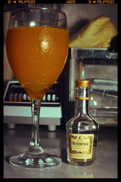Hennessey and orange juice in a wine glass Fitting dont u think?