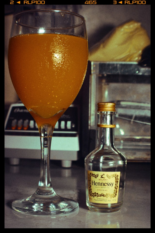 Porn Hennessey and orange juice in a wine glass photos