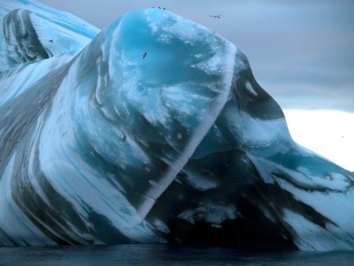 Amazing IcebergIcebergs sometimes are lined. When glaciers flow, they can pick up and carry sediment