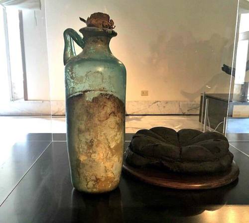 ancientorigins:Oldest olive oil - The nearly 2,000 year old bottle filled with solidified olive oil 