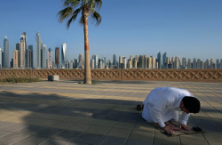 benadrylpapi:  April 6th, 2015. With the Marina skyline as a backdrop, a Muslim man performs the afternoon prayer on Jumeirah Palm Island’s walkway, in Dubai, United Arab Emirates.  Kamran Jebreili 