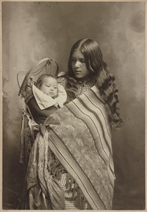 blondebrainpower:Studio portrait, woman from the Plateau region, possibly Spokane, with a baby in a cradleboard, by Martin Spencer, Wenatchee, Washington, 1902