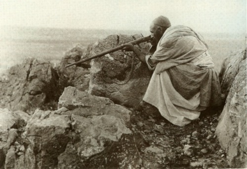 An Afridi tribesman takes aim with his musket, Khyber Pass, 1919.