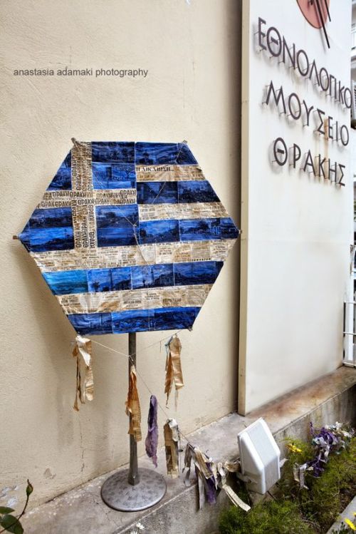Greek flag kite made of old newspapers outside of the Ethnological Museum of Thrace.