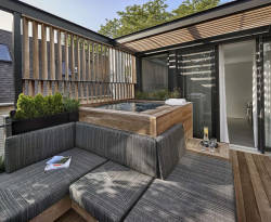 remodelproj:Built-in hot tub with seating around - side screen &amp; overhead trellis 